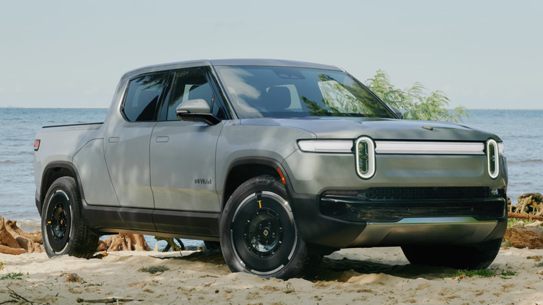 Front 3/4 view of Rivian R1T on beach