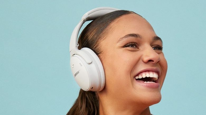 person smiling using Bose QuietComfort 45