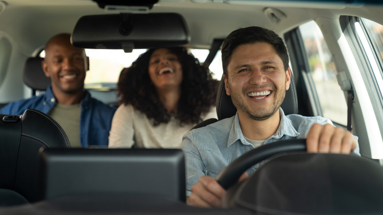 two passengers one smiling driver