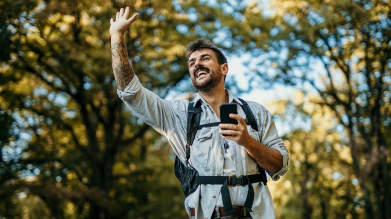 Man on a trip waving 