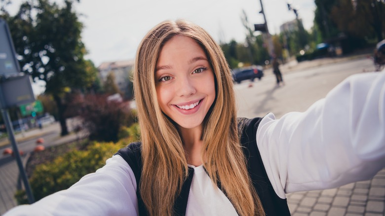 smiling woman taking a selfie