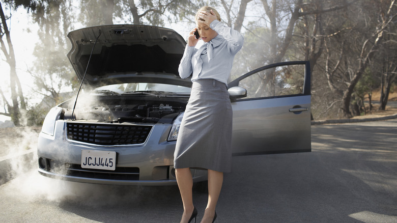 woman on phone smoking car