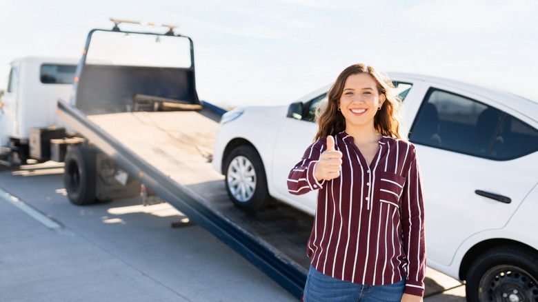 Woman with car being towed