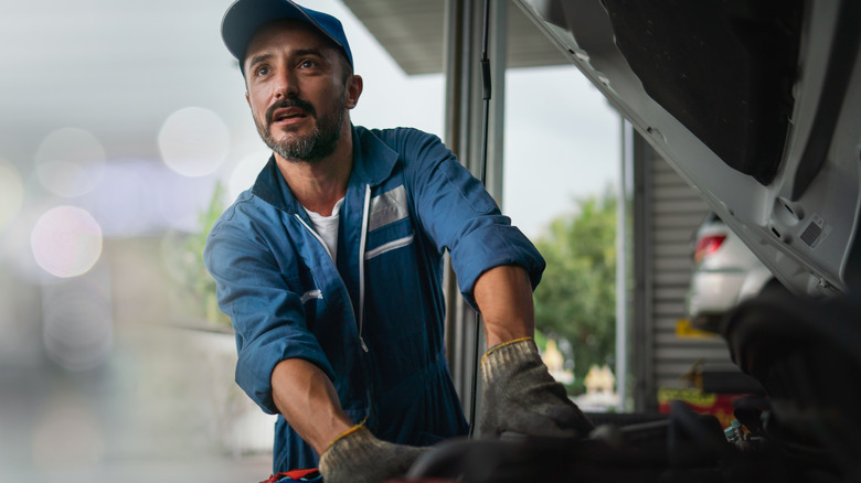 Automotive Mechanic Working On An Engine