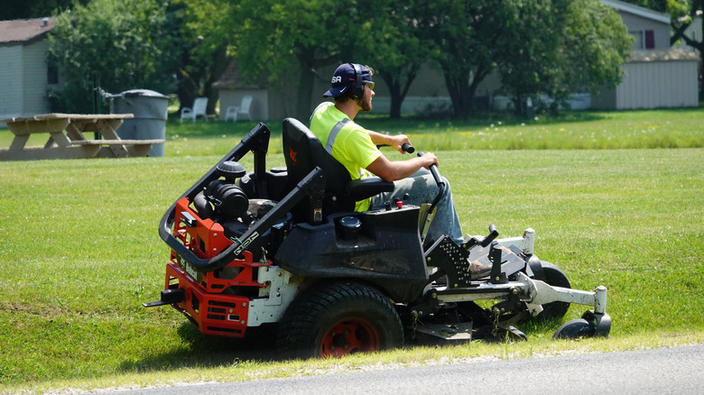 person using zero-turn mower