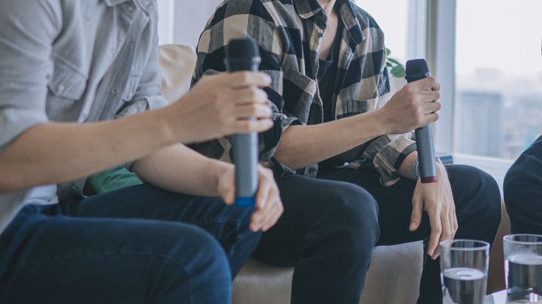 People holding wireless mics