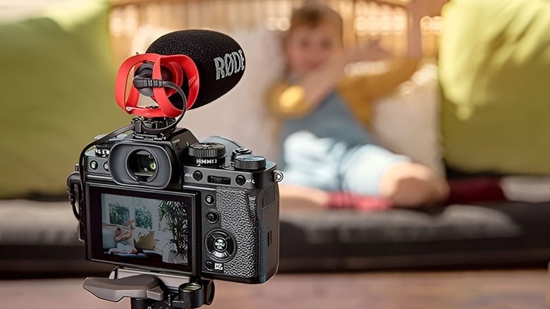 camera with Rode mic pointed at child