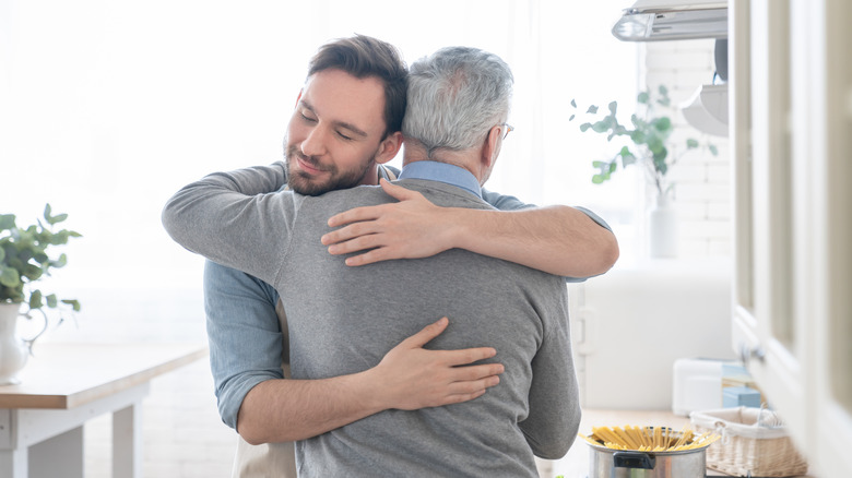 Man hugs father