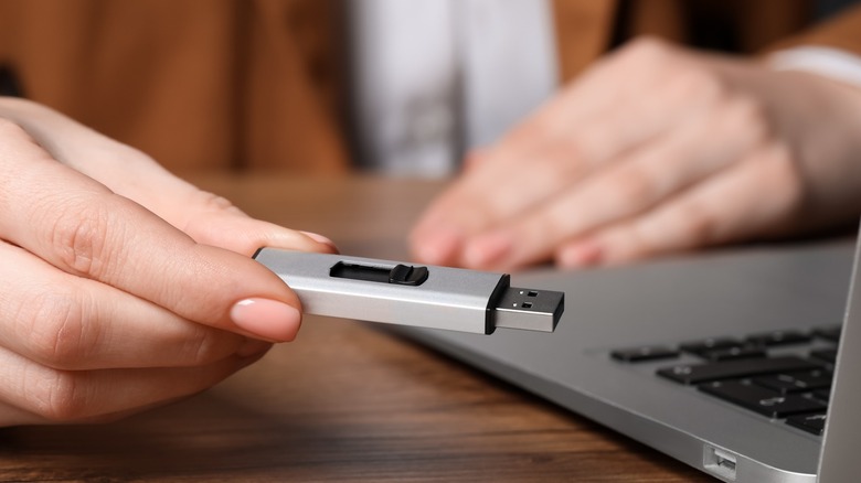 Woman holding a flash drive