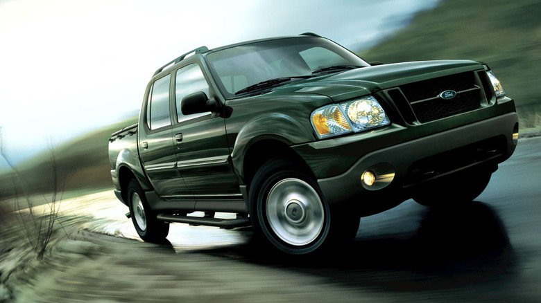 A 2003 Ford Explorer Sport Trac against a motion-blurred background.