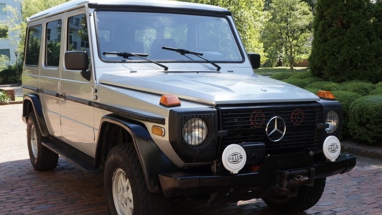 Silver Mercedes G-wagon parked on brick driveway