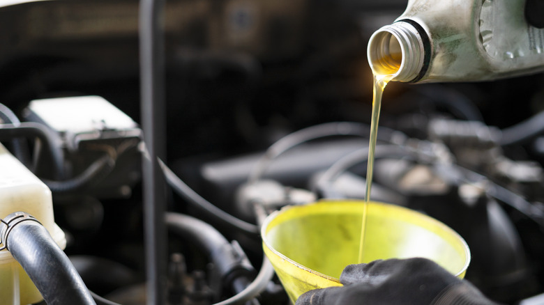 Close up of pouring oil during oil change