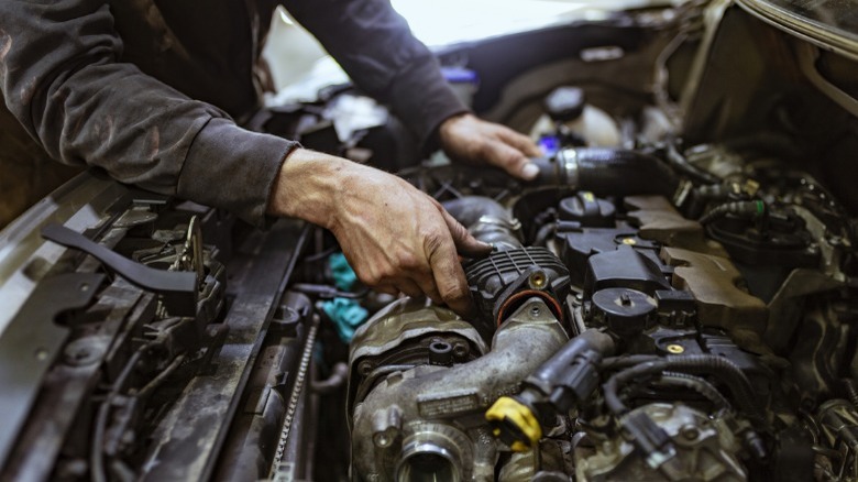 person working on an engine