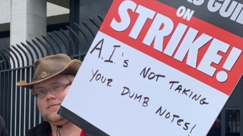 Man holding strike sign