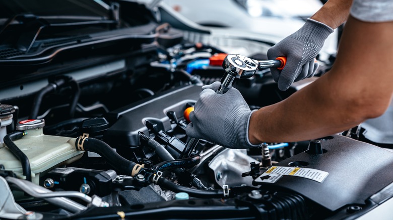 Person working on car