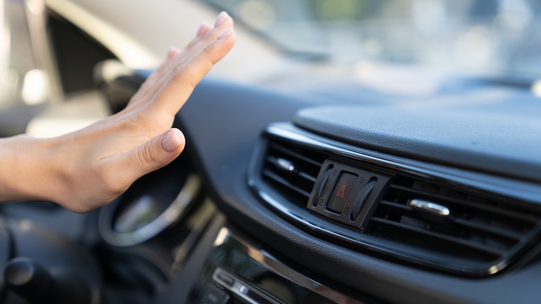 Hand over car AC vent