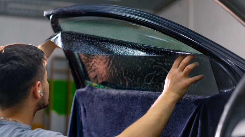 Man tinting car windows