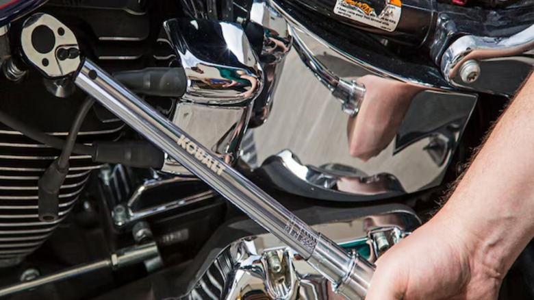 person using Kobalt torque wrench on motorcycle engine