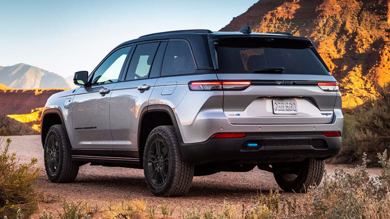 Silver Jeep Grand Cherokee parked on unpaved mountain road