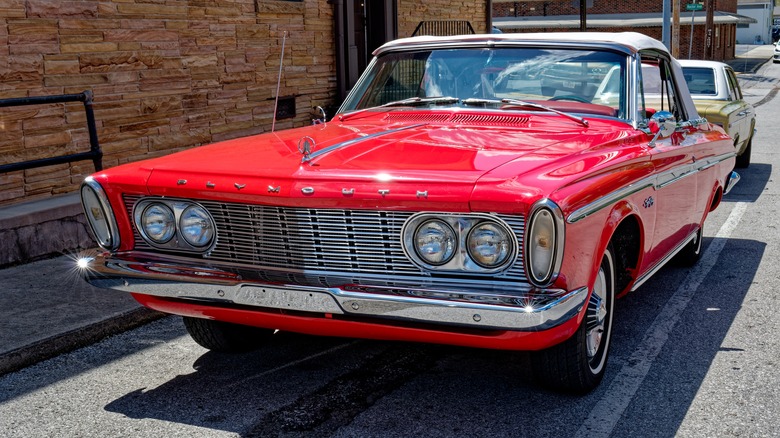 Plymouth Sport Fury parked by building