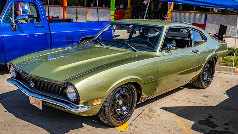 Green Ford Maverick parked street