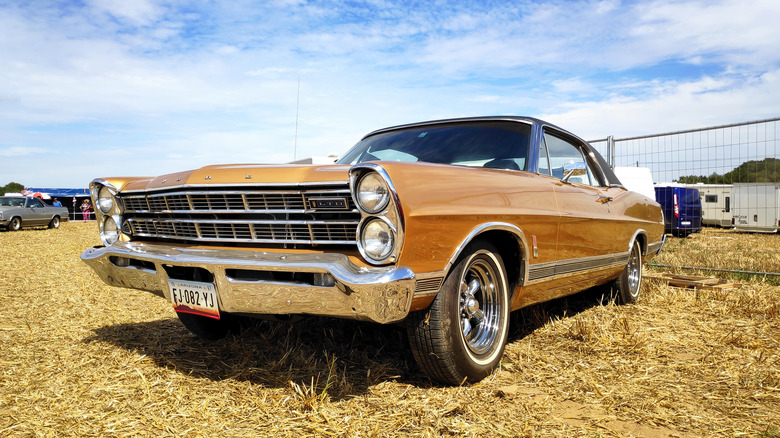 Gold Ford Galaxie parked on grass