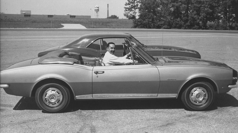 Head of General Motor's Chevrolet Division Elliot M. Estes sitting in the driver's seat of the 1967 Chevy Camaro.