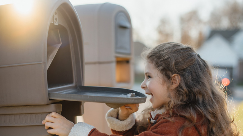 Girl opening mailbox