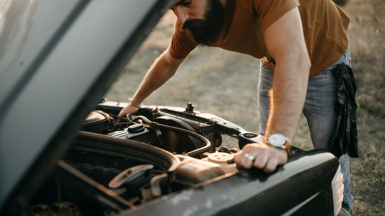 Man examining engine