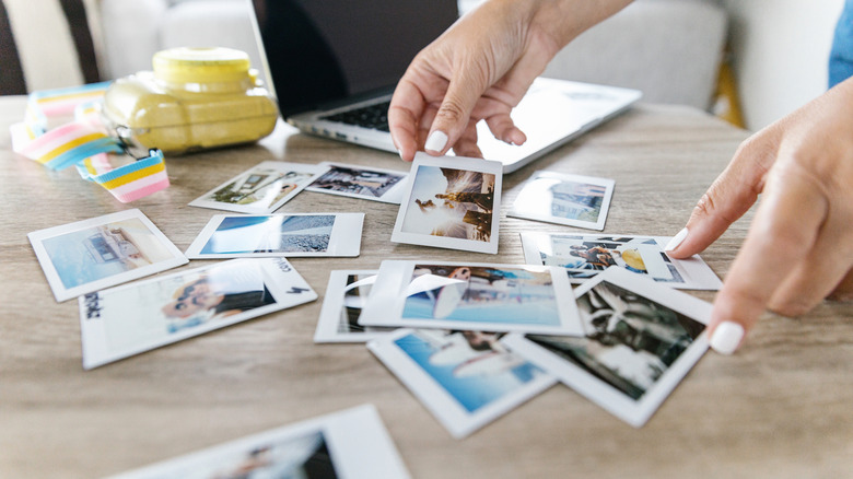 Person looking through printed photos