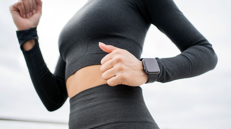 Woman running Apple Watch