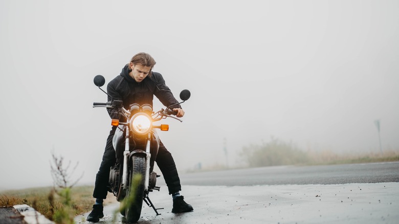 Man riding motorcycle in fog