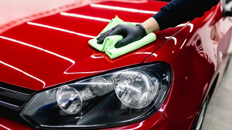 Microfiber cloth wiping red car