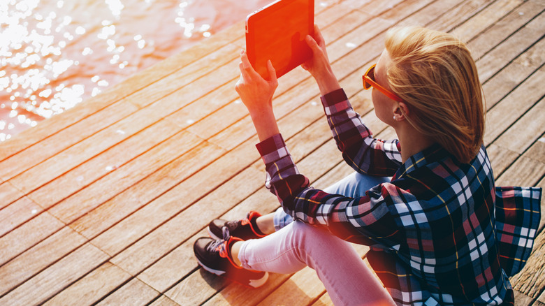 woman using iPad outside