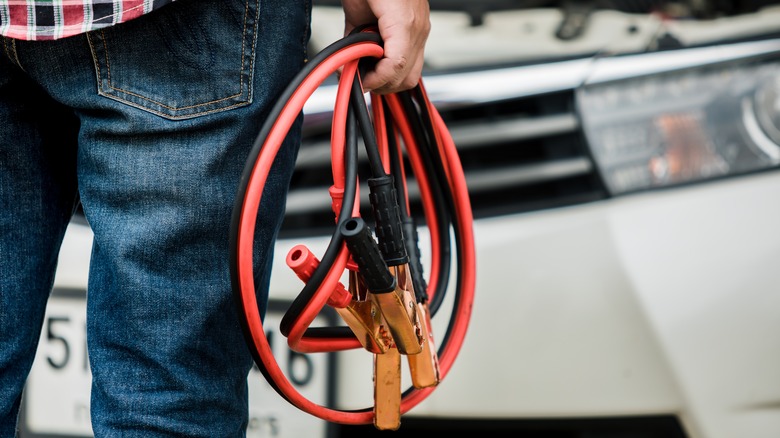 Man holding jumper cables