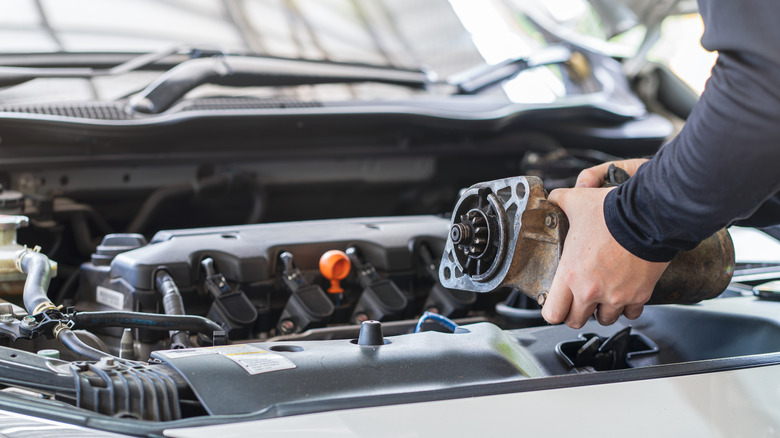 Man holding starter motor