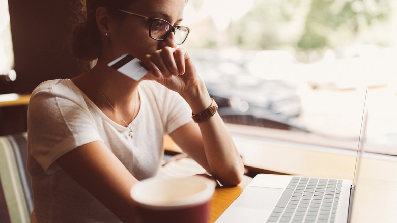 Woman with credit card at her laptop