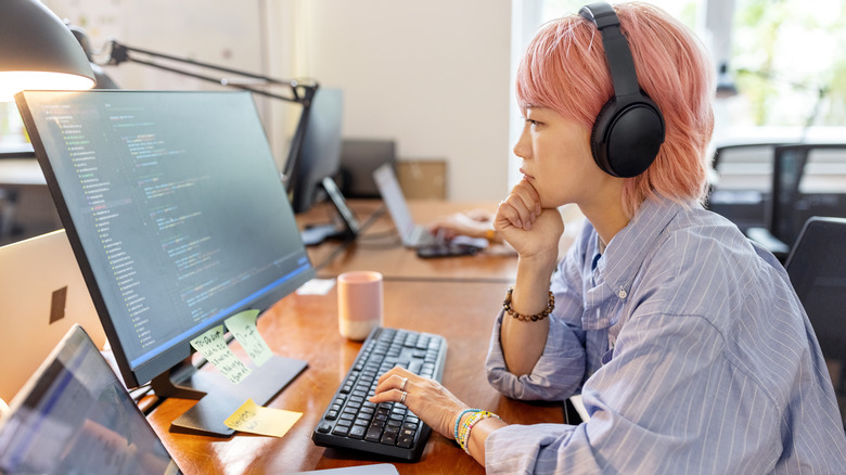 woman wearing headphones while working