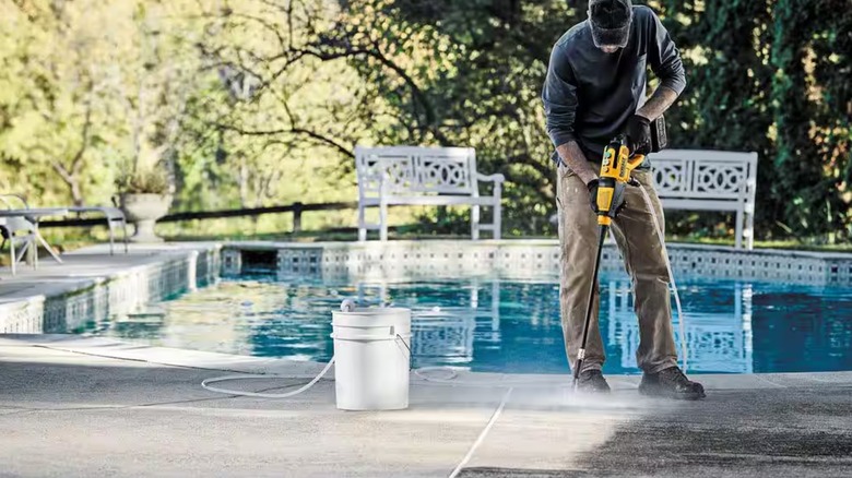 Cleaning by a pool with the DeWalt power cleaner