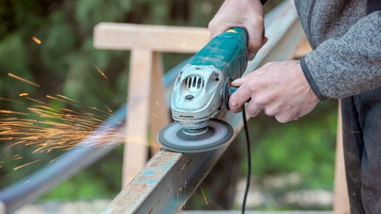 Person using angle grinder