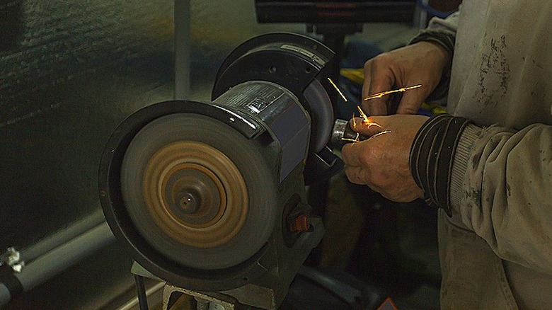 Person using bench grinder