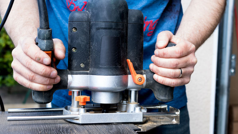 A Man Using A Plunge Router