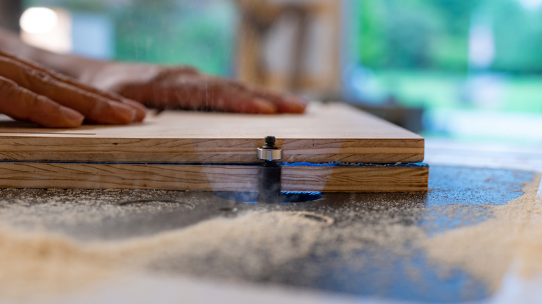 A Man Using A Router Table