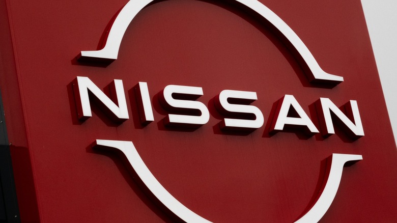 The Nissan logo in red and white