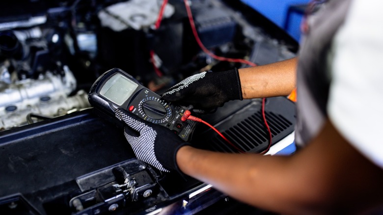 mechanic checking car battery