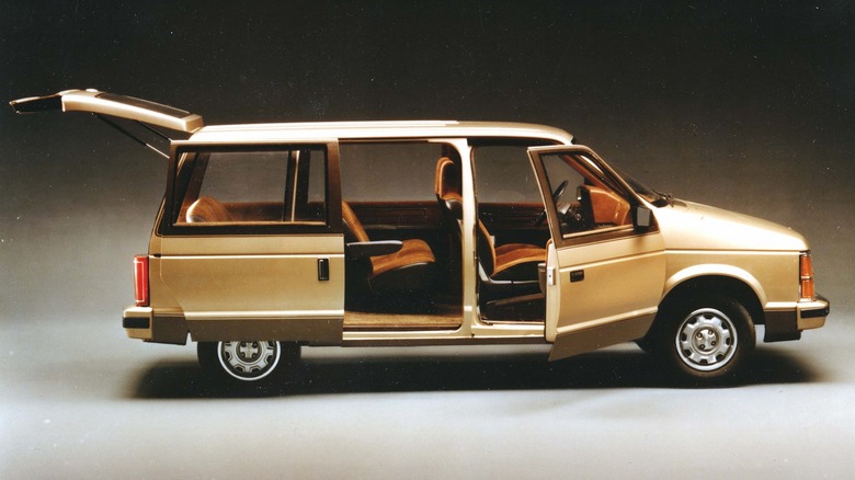 1984 Dodge Caravan in brown shown with the rear hatch, side sliding door and passenger door open