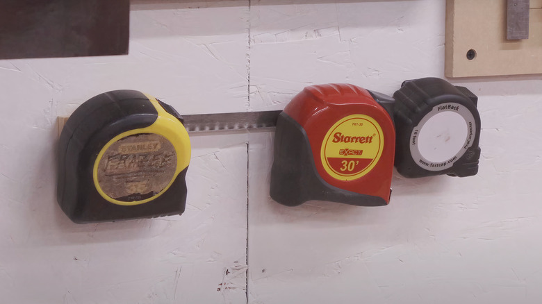 three tape measure rolls on hanger