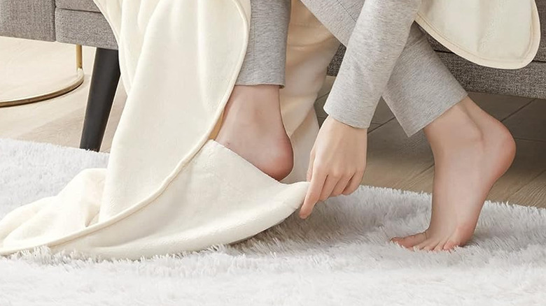 person using foot pocket of electric blanket