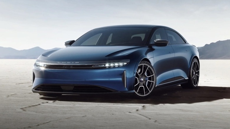 Lucid Air Sapphire parked on salt flats with mountains in the background