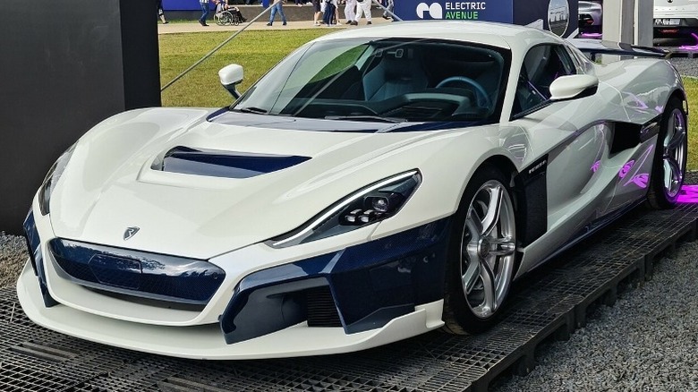 white Rimac Nevera parked on display pad in gravel